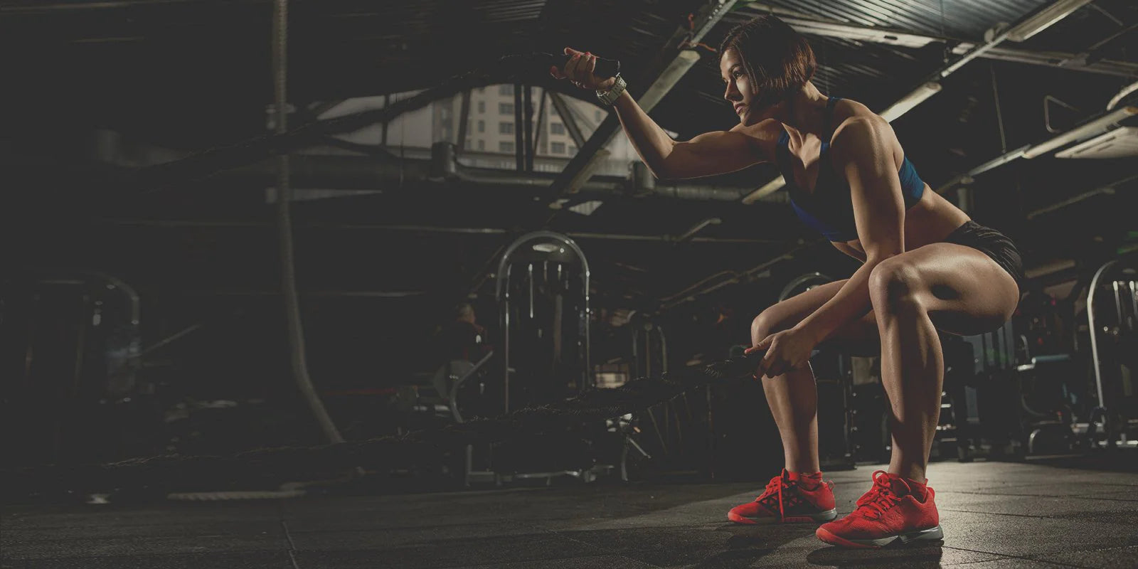 Woman working out with ropes.